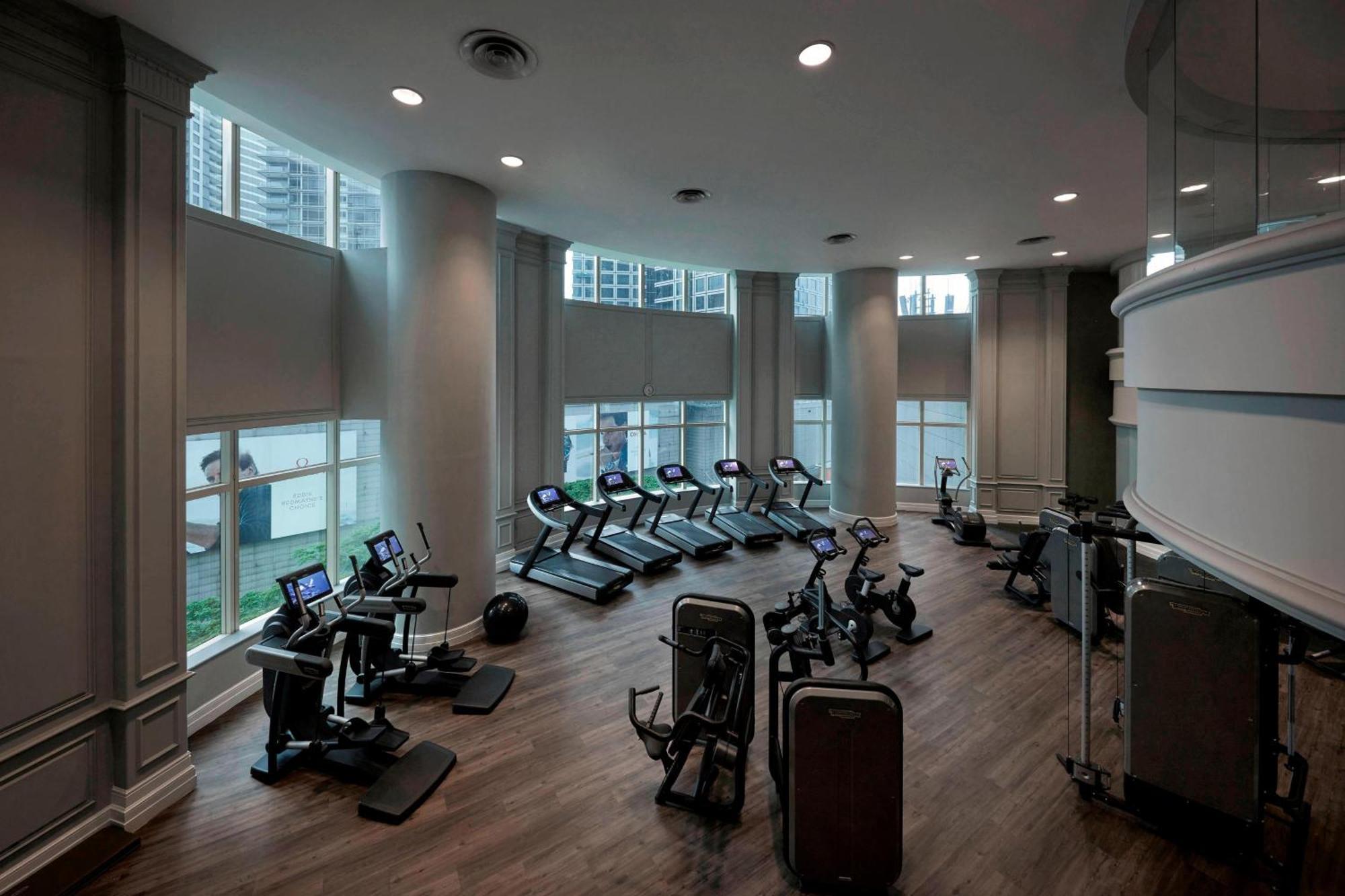 Jw Marriott Kuala Lumpur Hotel Exterior photo The photo shows an indoor gym or fitness area. It features several exercise machines, including treadmills and stationary bikes, arranged in a spacious layout. The walls are painted in neutral tones, and large windows allow natural light to fill the 
