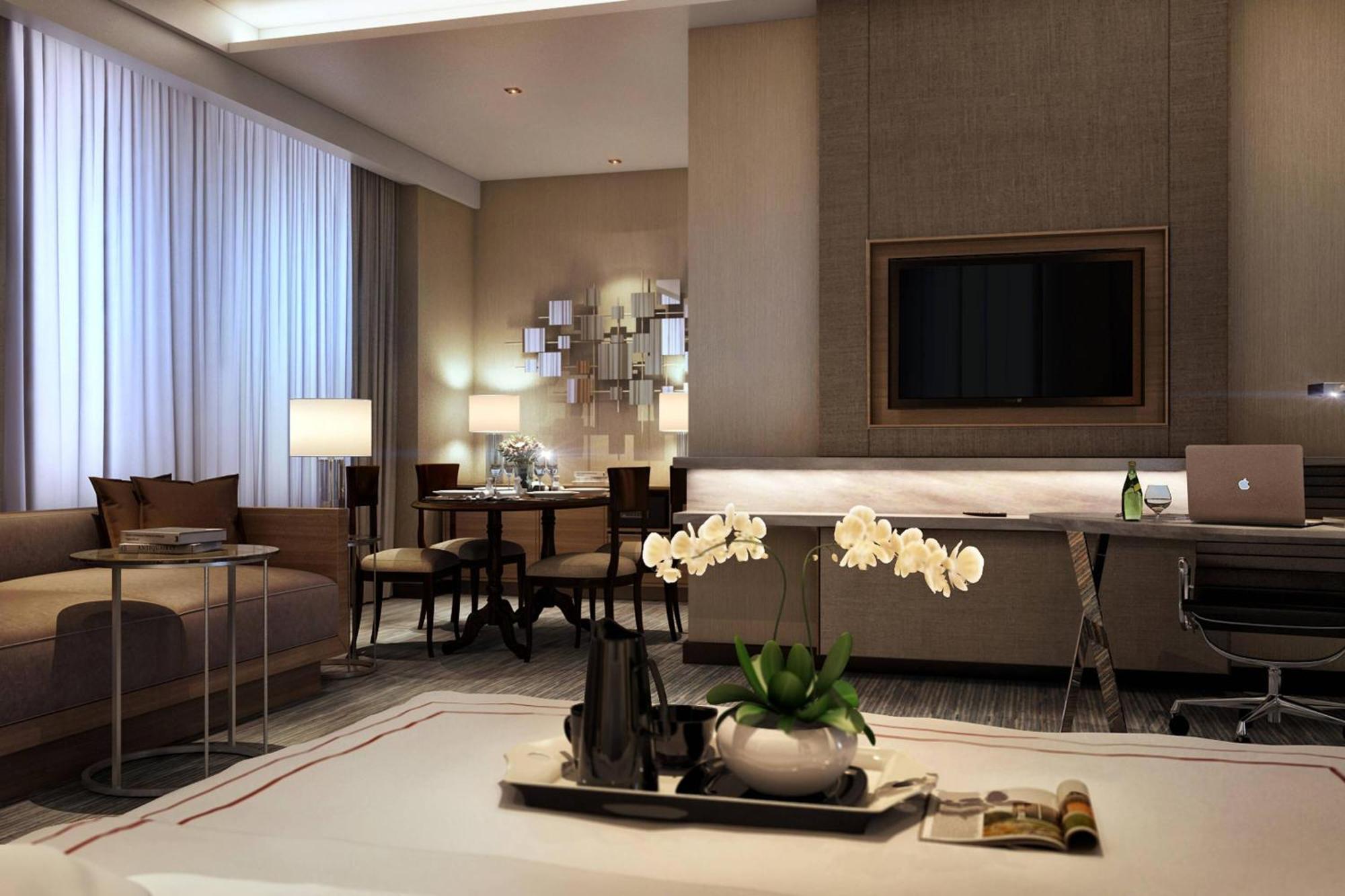 Jw Marriott Kuala Lumpur Hotel Exterior photo The photo shows a modern hotel room or a well-designed living space. It features large windows with sheer curtains that let in natural light. Decorative elements include a coffee table and elegant furniture, with a sofa in a neutral tone. There is a 